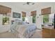 Cozy bedroom features a comfortable bed, serene decor, and natural light at 4541 School Rd, Land O Lakes, FL 34638