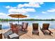 Beautiful dock featuring a dining table, lounge chairs, and stunning waterfront views at 4541 School Rd, Land O Lakes, FL 34638