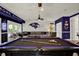 Entertaining game room featuring a pool table, comfortable seating, and unique Baltimore Ravens decor at 4541 School Rd, Land O Lakes, FL 34638