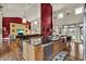 A kitchen boasts an island with black countertops, and wood cabinets, adjacent to a dining and living area at 4541 School Rd, Land O Lakes, FL 34638