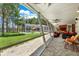 Spacious screened lanai offers outdoor living with view of pool, lush landscaping and comfortable lounging areas at 4541 School Rd, Land O Lakes, FL 34638
