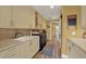 Well-equipped laundry room with ample counter space, cabinetry, a sink, and modern appliances at 4541 School Rd, Land O Lakes, FL 34638