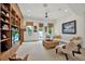 Inviting living room with a built-in entertainment center and comfortable seating by bright, sunny windows at 4541 School Rd, Land O Lakes, FL 34638