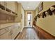 Functional mudroom with built-in storage, a wooden bench, and access to the outdoors at 4541 School Rd, Land O Lakes, FL 34638