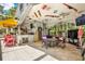 Unique enclosed pool area features a bar, seating, entertainment, and protection from sun creating a fun outdoor oasis at 4541 School Rd, Land O Lakes, FL 34638