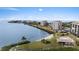Aerial view of coastal community with condos, a pool, and waterfront access with a sandy beach at 4550 Bay Blvd # 1231, Port Richey, FL 34668