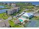 An aerial view showcases the property's lush landscaping, pool, tennis court, and desirable waterfront location at 4550 Bay Blvd # 1231, Port Richey, FL 34668
