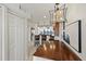 View of the dining area featuring a table, a modern chandelier, and an open view of the kitchen and water at 4550 Bay Blvd # 1231, Port Richey, FL 34668
