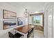 Charming dining area featuring a table, designer chandelier, and a window with an outdoor view and a brick accent wall at 4550 Bay Blvd # 1231, Port Richey, FL 34668