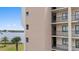 Exterior view of condo building showing balcony, flat siding, and an idyllic waterfront view of a bay at 4550 Bay Blvd # 1231, Port Richey, FL 34668