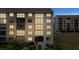 Exterior view of the condo building showing well-lit windows and surrounding landscaping at 4550 Bay Blvd # 1231, Port Richey, FL 34668