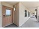 Exterior hallway with door to condo, a window, and a view down the hallway with black railings at 4550 Bay Blvd # 1231, Port Richey, FL 34668