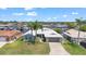 An aerial view of the property featuring manicured landscaping, and neighborhood canal views at 4918 Forecastle Dr, New Port Richey, FL 34652