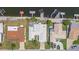 Aerial view of the home with a white tile roof, adjacent to waterfront canals and docks at 4918 Forecastle Dr, New Port Richey, FL 34652