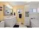 Bright bathroom featuring yellow walls, white vanity, and a window for natural light above the toilet at 4918 Forecastle Dr, New Port Richey, FL 34652