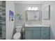 Stylish bathroom featuring a vanity with marble countertop and blue cabinets, complemented by a framed mirror at 4918 Forecastle Dr, New Port Richey, FL 34652
