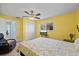 Sunny bedroom featuring a ceiling fan, closet, bed with floral coverlet, and wood-look floors at 4918 Forecastle Dr, New Port Richey, FL 34652