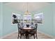 Cozy dining area bathed in soft natural light showcasing harbor views from the surrounding windows at 4918 Forecastle Dr, New Port Richey, FL 34652