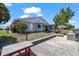 Exterior view of a light gray home with a metal roof, boat dock, chain link fence, and boat lift at 4918 Forecastle Dr, New Port Richey, FL 34652