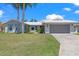 Charming single-story home featuring a tile roof, well-manicured lawn, and an attached two-car garage at 4918 Forecastle Dr, New Port Richey, FL 34652