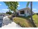 Waterfront home featuring lush landscaping, attached dock, and waterside patio perfect for outdoor living at 4918 Forecastle Dr, New Port Richey, FL 34652