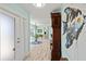 Open and bright hallway leading into the house featuring wood-look flooring and serene paint at 4918 Forecastle Dr, New Port Richey, FL 34652