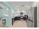 Modern kitchen featuring stainless steel appliances, a mosaic backsplash and two-toned cabinetry at 4918 Forecastle Dr, New Port Richey, FL 34652