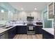 Modern kitchen featuring stainless steel appliances, a mosaic backsplash and two-toned cabinetry at 4918 Forecastle Dr, New Port Richey, FL 34652
