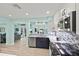 Bright open kitchen featuring stainless steel appliances, a mosaic backsplash and two-toned cabinetry at 4918 Forecastle Dr, New Port Richey, FL 34652
