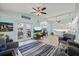 Bright open living room with wood floors, ceiling fans, and water views at 4918 Forecastle Dr, New Port Richey, FL 34652