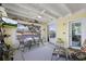 Cozy sunroom with water views, yellow walls, white ceiling, and comfortable seating at 4918 Forecastle Dr, New Port Richey, FL 34652