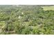 Overhead view of a sprawling wooded property with a residence nestled among the trees and landscaping at 5113 Cedar Ln, Brooksville, FL 34601
