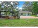 Expansive backyard featuring a brick patio, pergola with bar, and ample space for outdoor entertaining at 5113 Cedar Ln, Brooksville, FL 34601