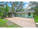 A spacious backyard with a brick patio provides plenty of room to relax and enjoy the outdoors at 5113 Cedar Ln, Brooksville, FL 34601