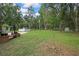 The expansive backyard offers a serene setting with an above-ground pool and lush greenery at 5113 Cedar Ln, Brooksville, FL 34601