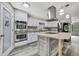 Stylish kitchen with stainless steel appliances, double oven, a rustic center island and pantry door at 5113 Cedar Ln, Brooksville, FL 34601