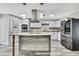 Modern kitchen features stainless steel appliances, a center island, and white cabinetry for a clean, contemporary design at 5113 Cedar Ln, Brooksville, FL 34601