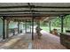 The covered patio, with its bar, seating, and brick flooring, creates an inviting outdoor living space at 5113 Cedar Ln, Brooksville, FL 34601