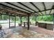 Covered patio with brick flooring, a bar and a table and benches that makes the perfect outdoor entertaining area at 5113 Cedar Ln, Brooksville, FL 34601