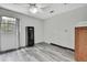Room with gray wood floors, a ceiling fan, and natural light from a window at 5113 Cedar Ln, Brooksville, FL 34601