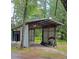 Open-sided shed with a metal roof, wooden supports, and a lean-to structure to the side, ideal for outdoor storage at 5113 Cedar Ln, Brooksville, FL 34601