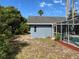 View of a screened-in swimming pool area with landscaping and backyard foliage at 5294 Elkin Ave, Spring Hill, FL 34606