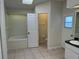 Bright bathroom with a soaking tub, tiled floor, and a separate toilet area at 5294 Elkin Ave, Spring Hill, FL 34606