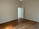 Simple bedroom featuring hardwood floors, neutral walls, and a ceiling fan at 5294 Elkin Ave, Spring Hill, FL 34606
