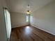 Bright bedroom with hardwood floors, ceiling fan, and natural light from windows at 5294 Elkin Ave, Spring Hill, FL 34606