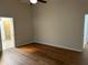 Bright bedroom with hardwood floors and an open doorway to an en-suite bathroom at 5294 Elkin Ave, Spring Hill, FL 34606