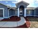 Charming blue home featuring a columned entrance, well-kept landscape, and a inviting pathway at 5294 Elkin Ave, Spring Hill, FL 34606