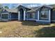 Charming blue home with a landscaped front yard and well maintained yard at 5294 Elkin Ave, Spring Hill, FL 34606