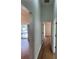 Hallway featuring hardwood floors, leading to sliding doors with views of the pool at 5294 Elkin Ave, Spring Hill, FL 34606