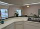 Spacious kitchen with white cabinets, a green countertop, and stainless steel sink fixtures at 5294 Elkin Ave, Spring Hill, FL 34606